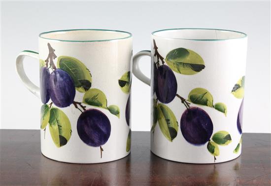 A pair of Wemyss plum pattern mugs, early 20th century, 14.5cm, faultes